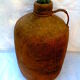 Demijohn dressed in burlap and padded cork