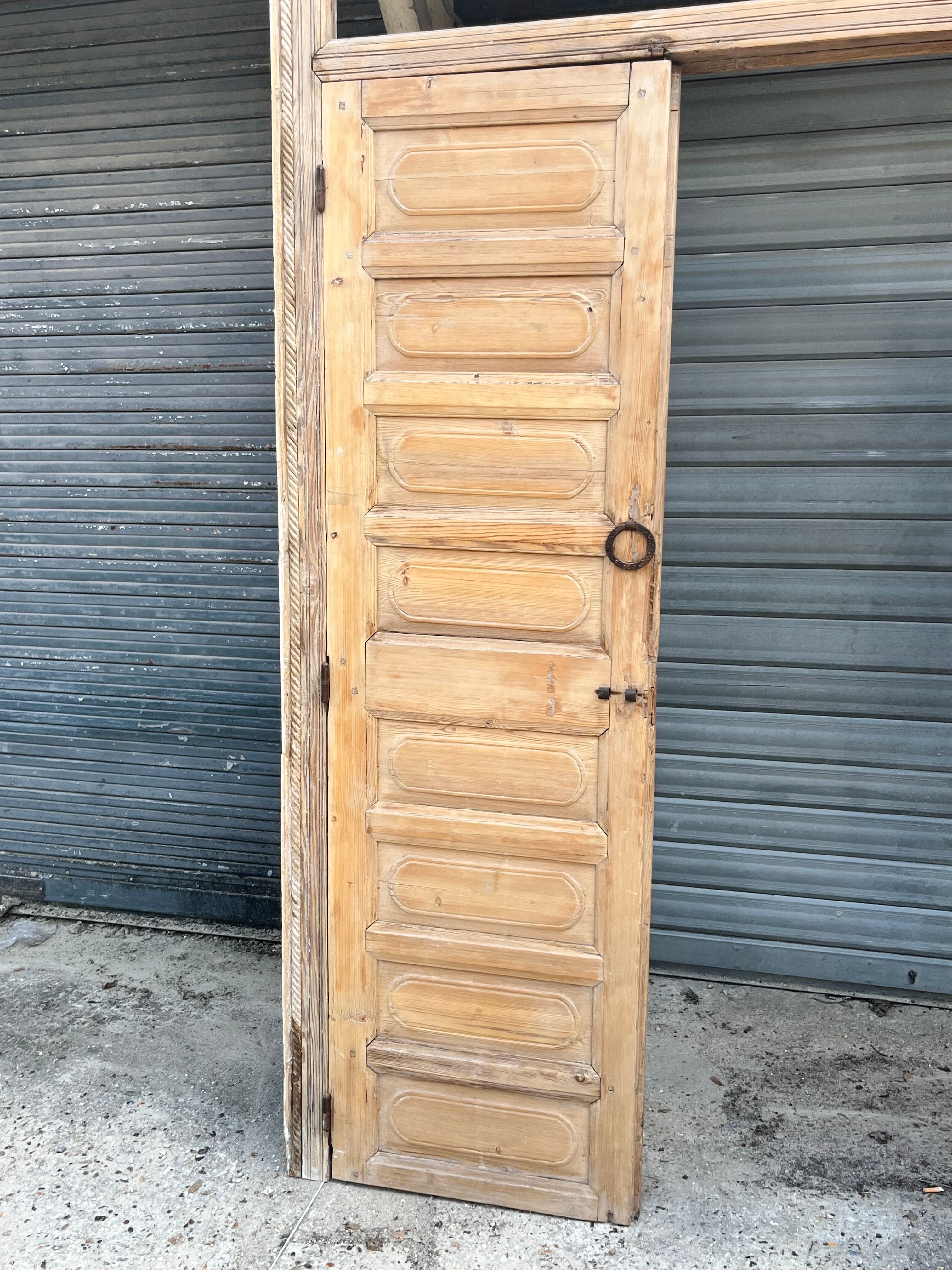 pair of old double-leaf doors with transom and carved frames