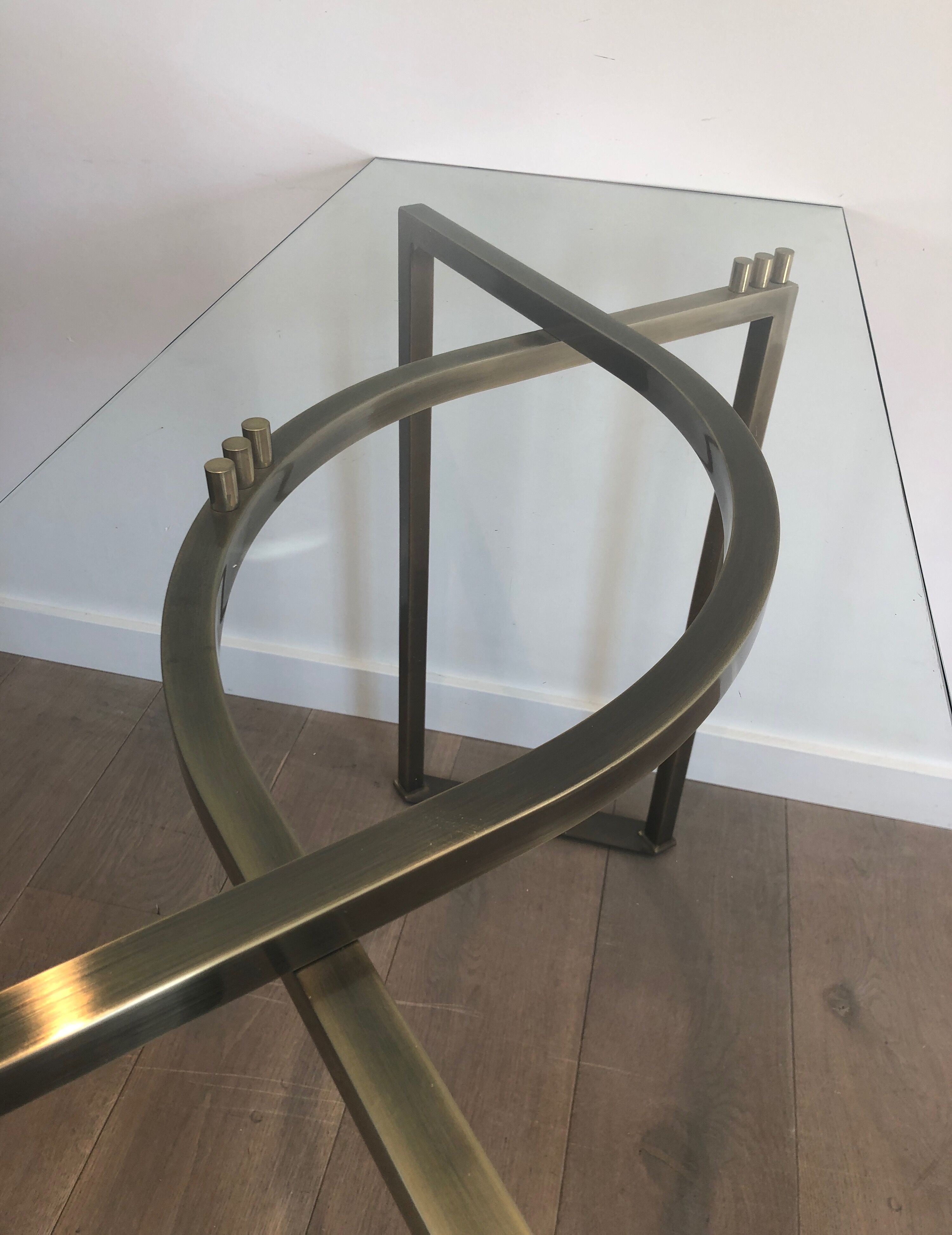 Console in brushed steel and brass and tray formed of a glass slab. French work. Around 1970