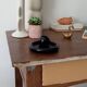 Vintage black ceramic candle holder on a bowl