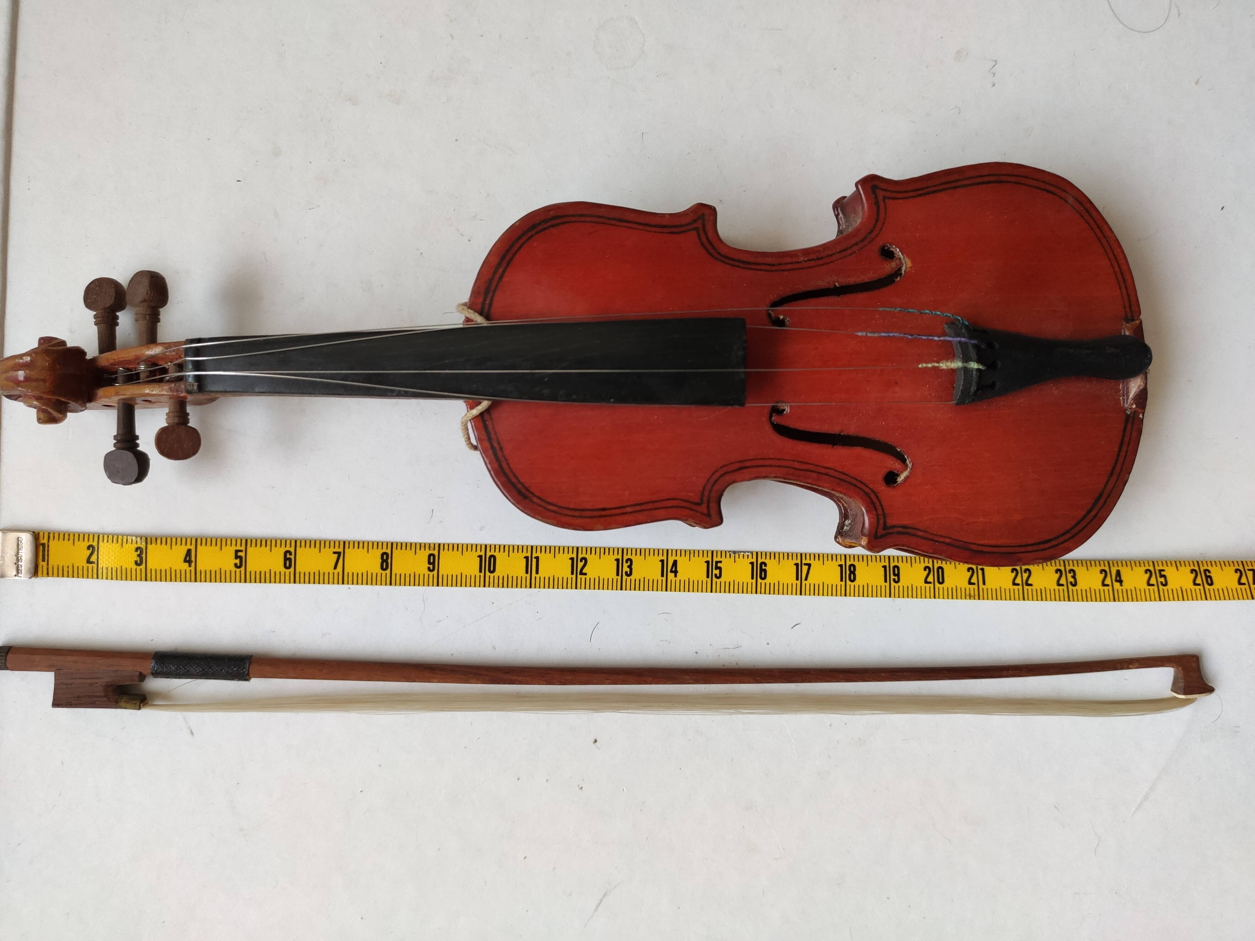 violin and decorative archer in antique varnished wood