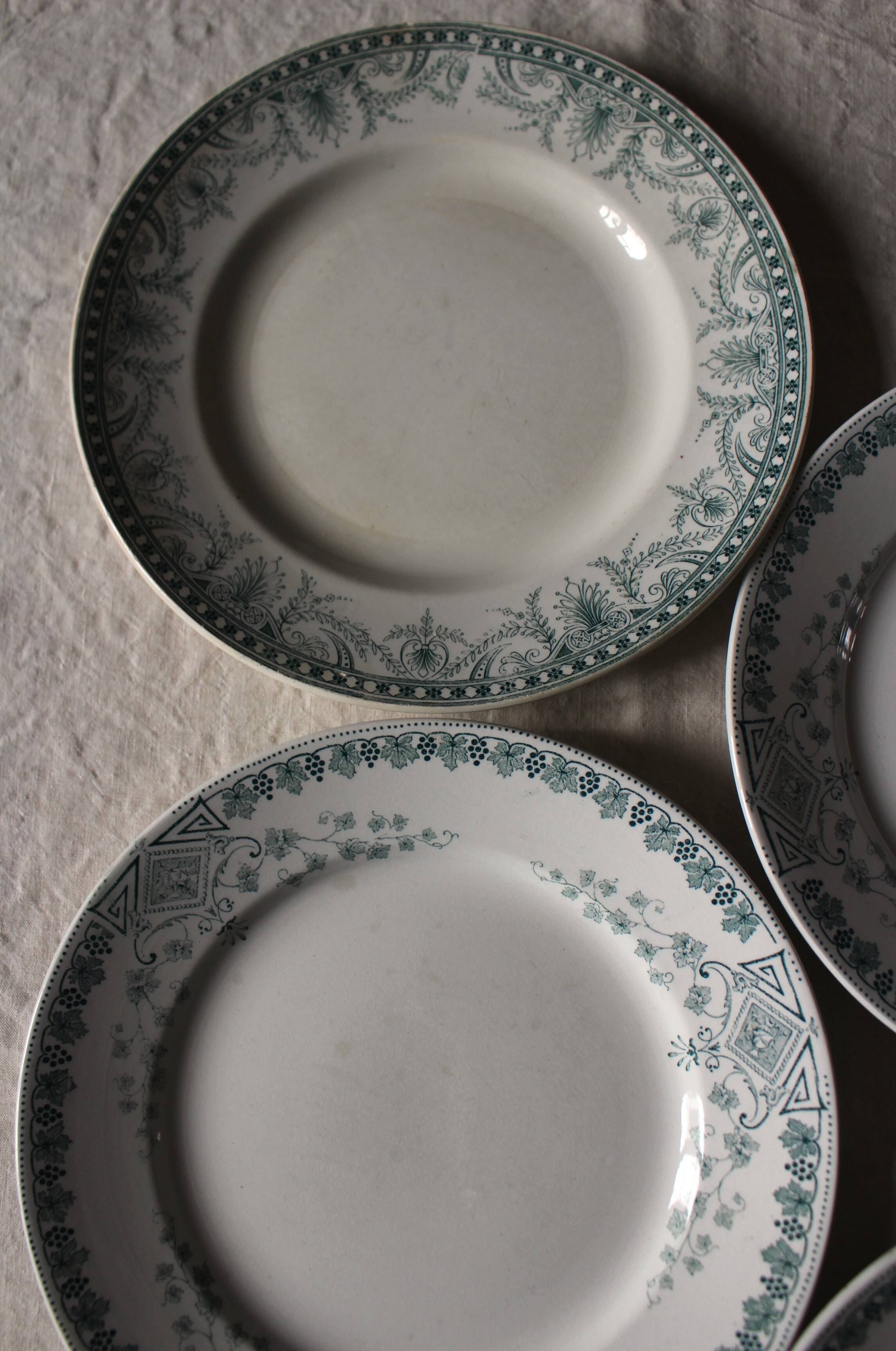 A set of 5 mismatched green blue Terre de fer flat plates