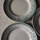 A set of 5 mismatched green blue Terre de fer flat plates