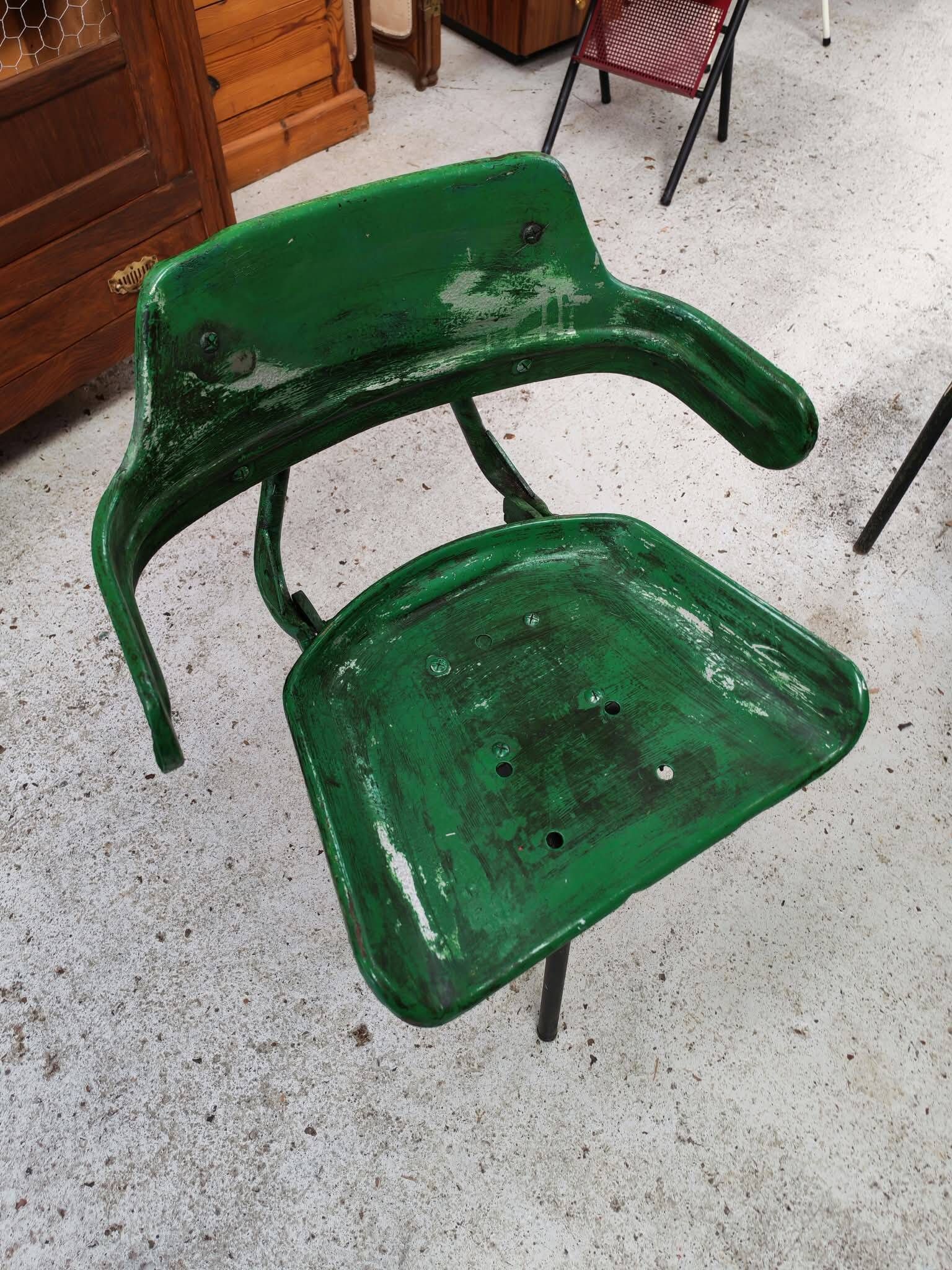 Vintage swivel workshop chair in green pressed sheet metal with a folding backrest.