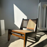 Reclined armchair in canned teak in natural wood