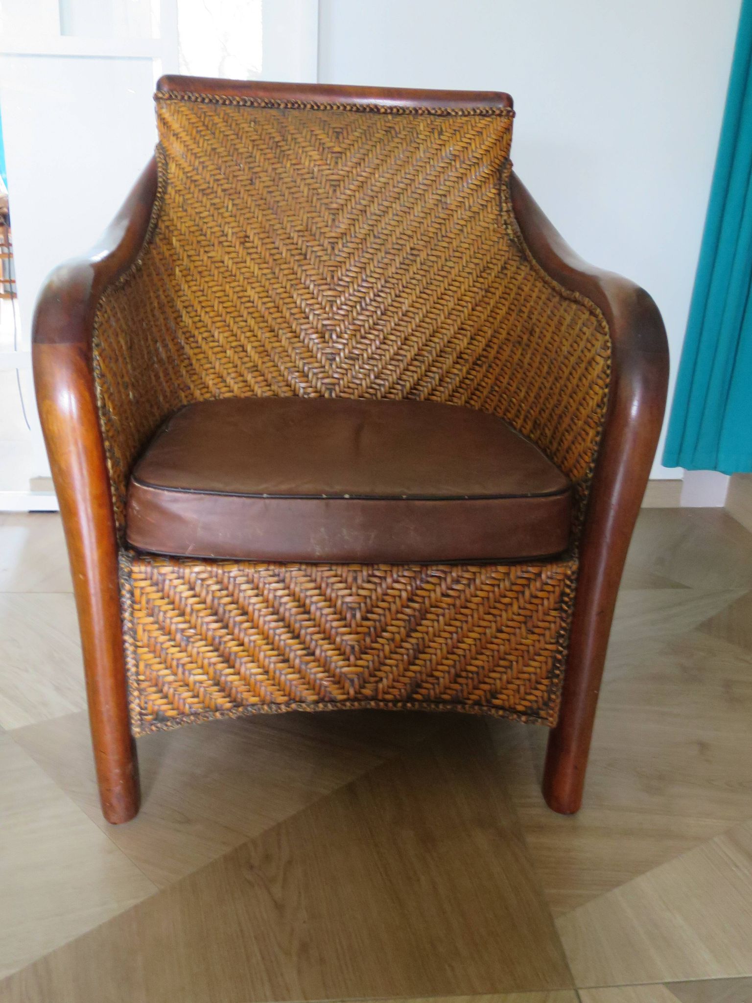 Woven rattan armchair and exotic wood in colonial style, 1980s.