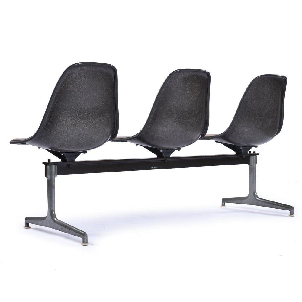 Tandem bench with brown Naugahyde pad shell chairs by Charles and Ray Eames for Herman Miller