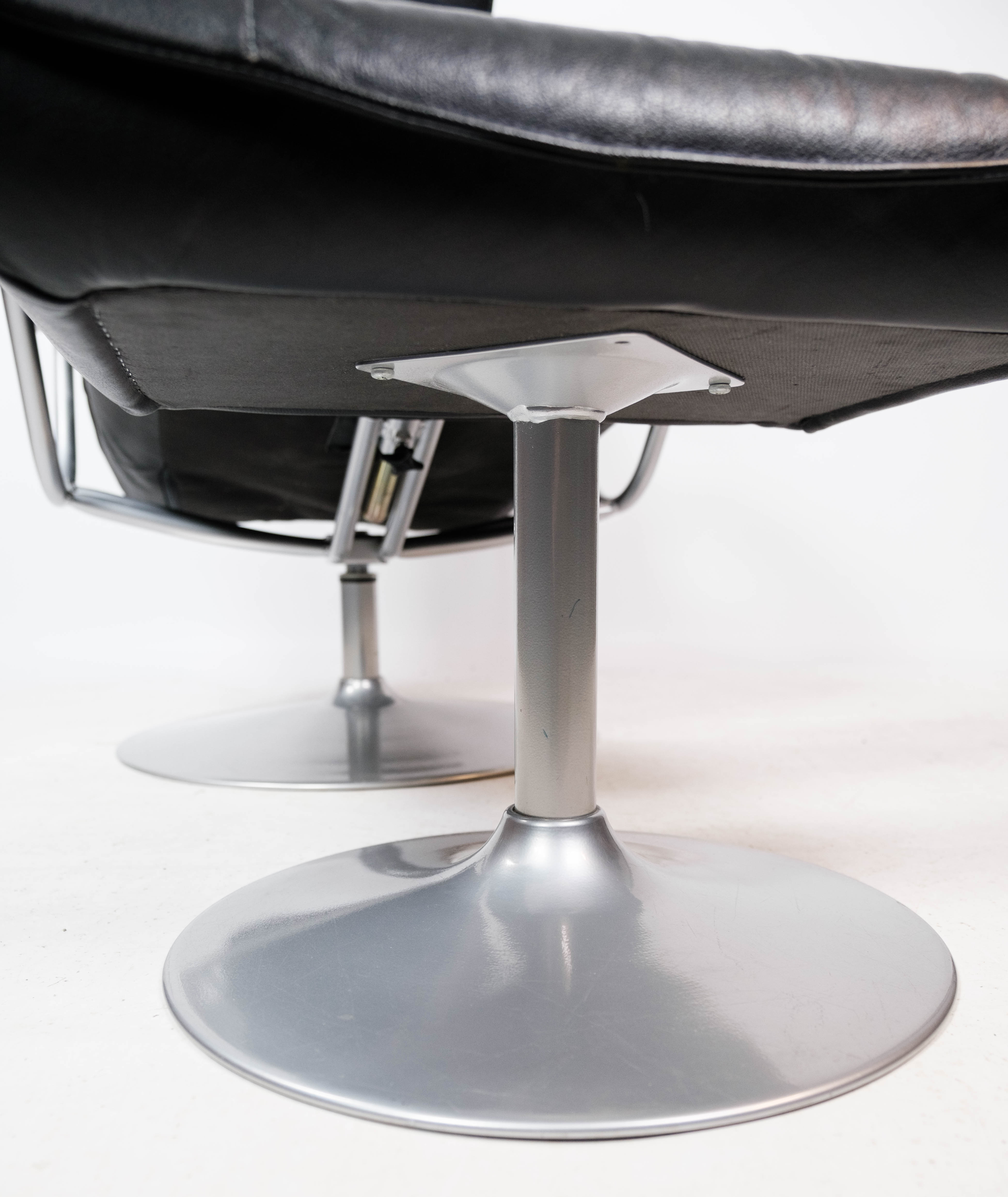 Easy chair with stool upholstered with black leather of Danish design, 1970s