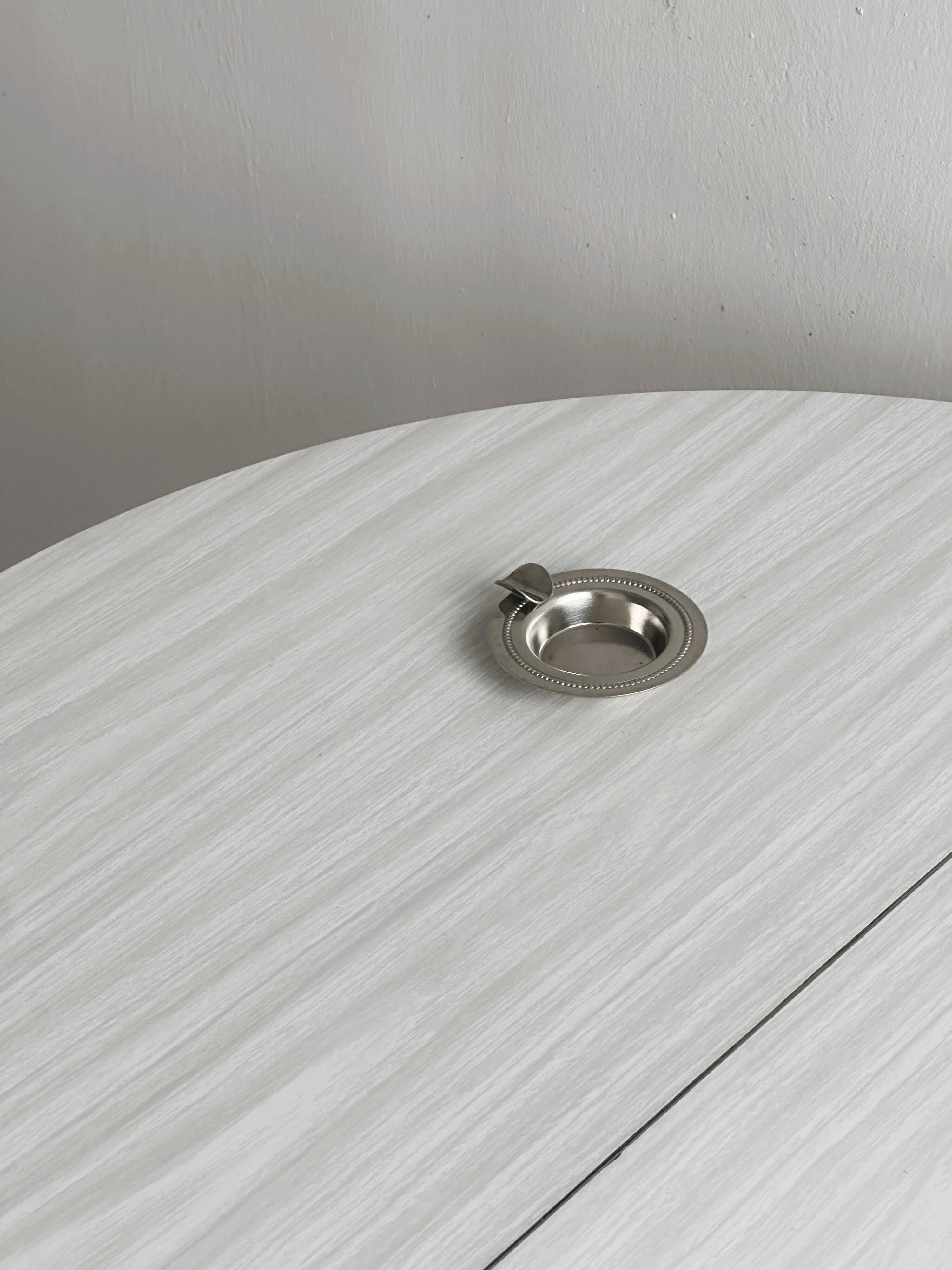 Small ashtray in shiny silver metal