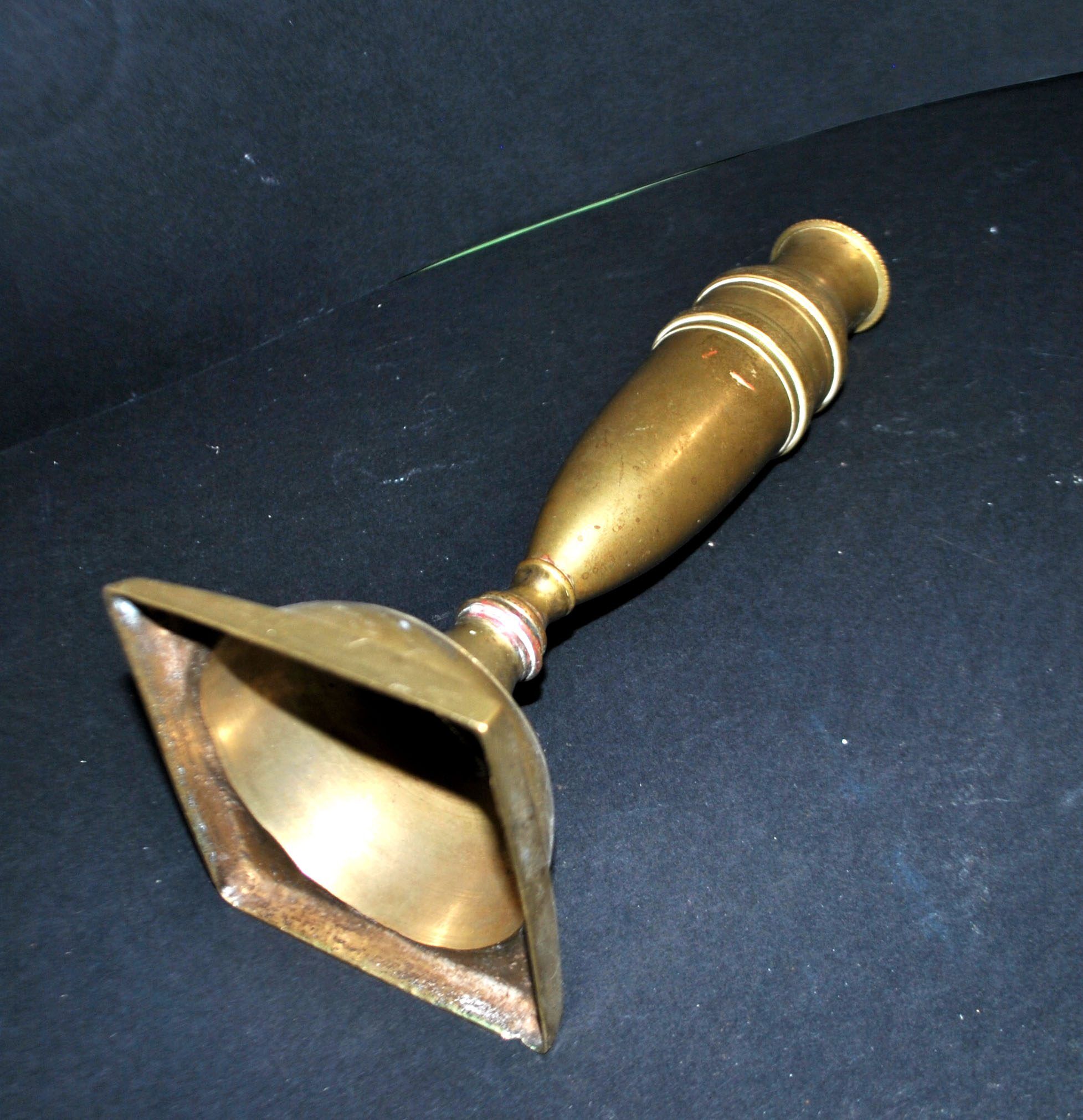 Antique baluster candlestick in bronze with hand-chiseled design.