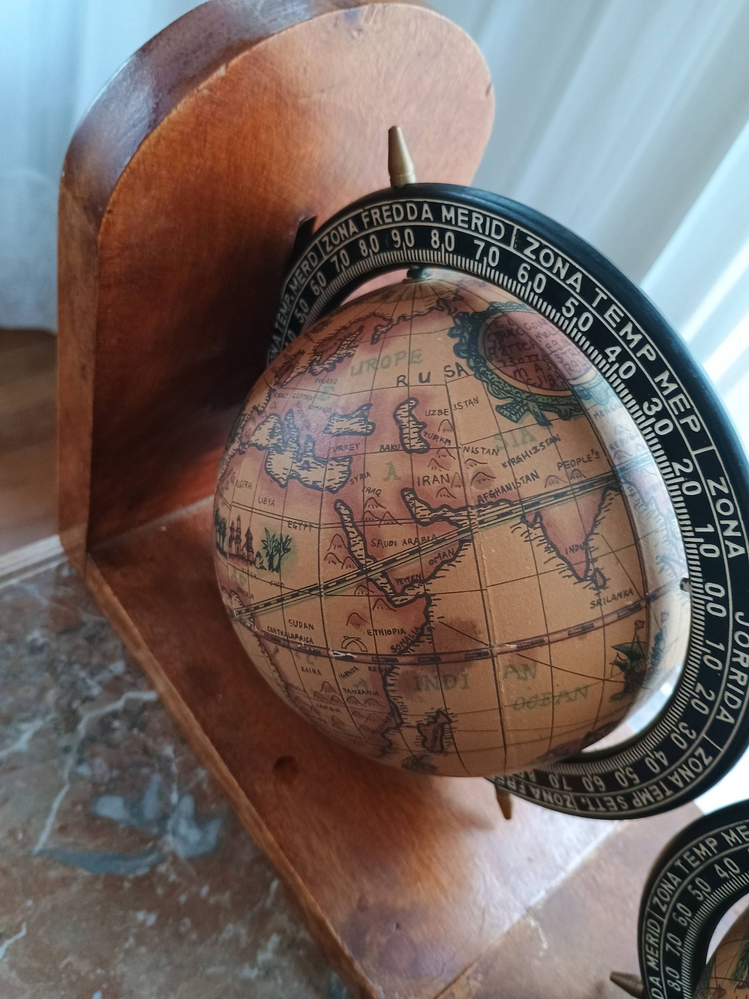 Pair of vintage bookends with rotating terrestrial globes on wooden bases in Spain