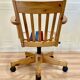 Solid wood swivel and reclining armchair.
