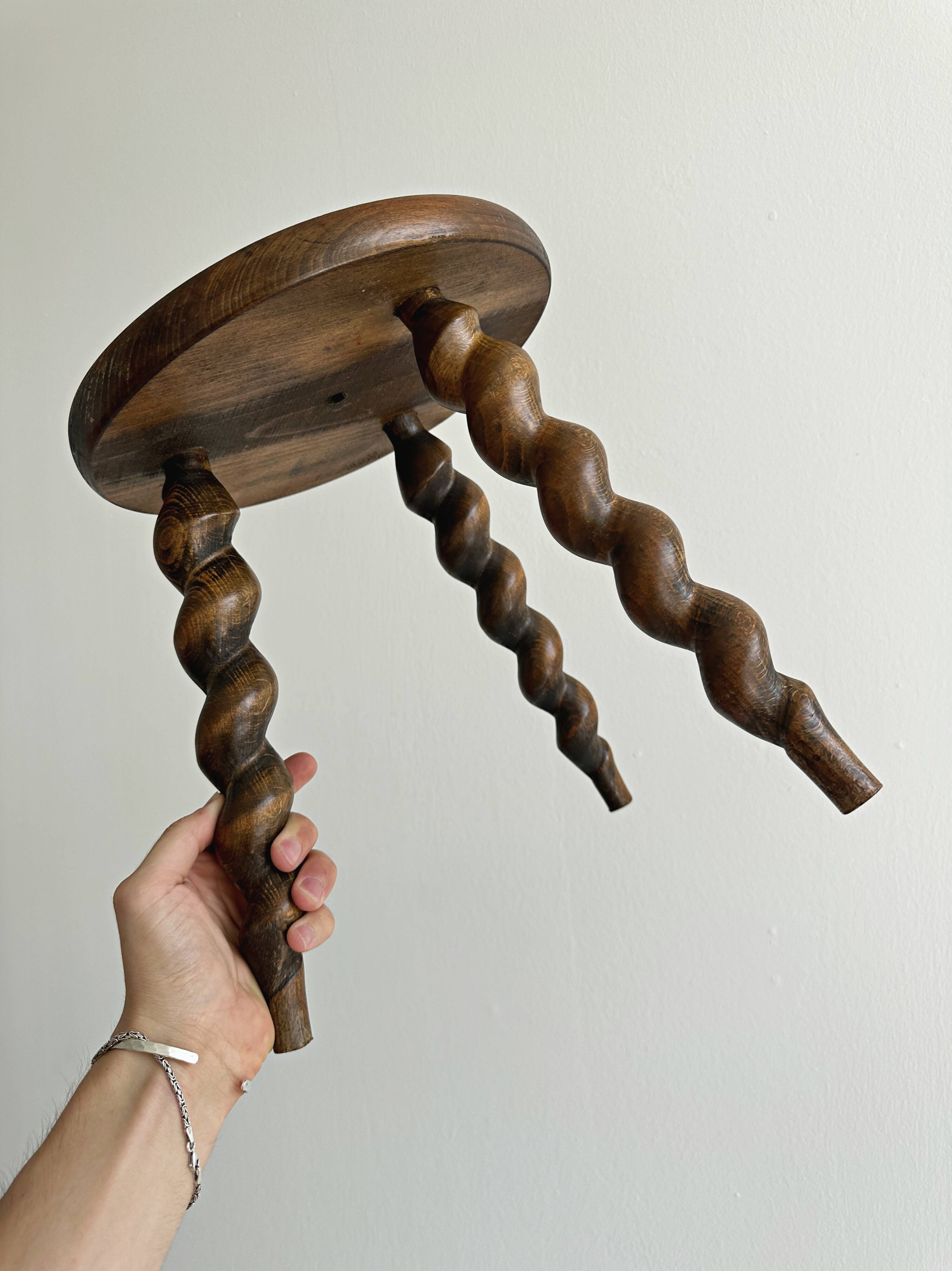 Small antique tripod stool in dark wood.