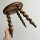 Small antique tripod stool in dark wood.