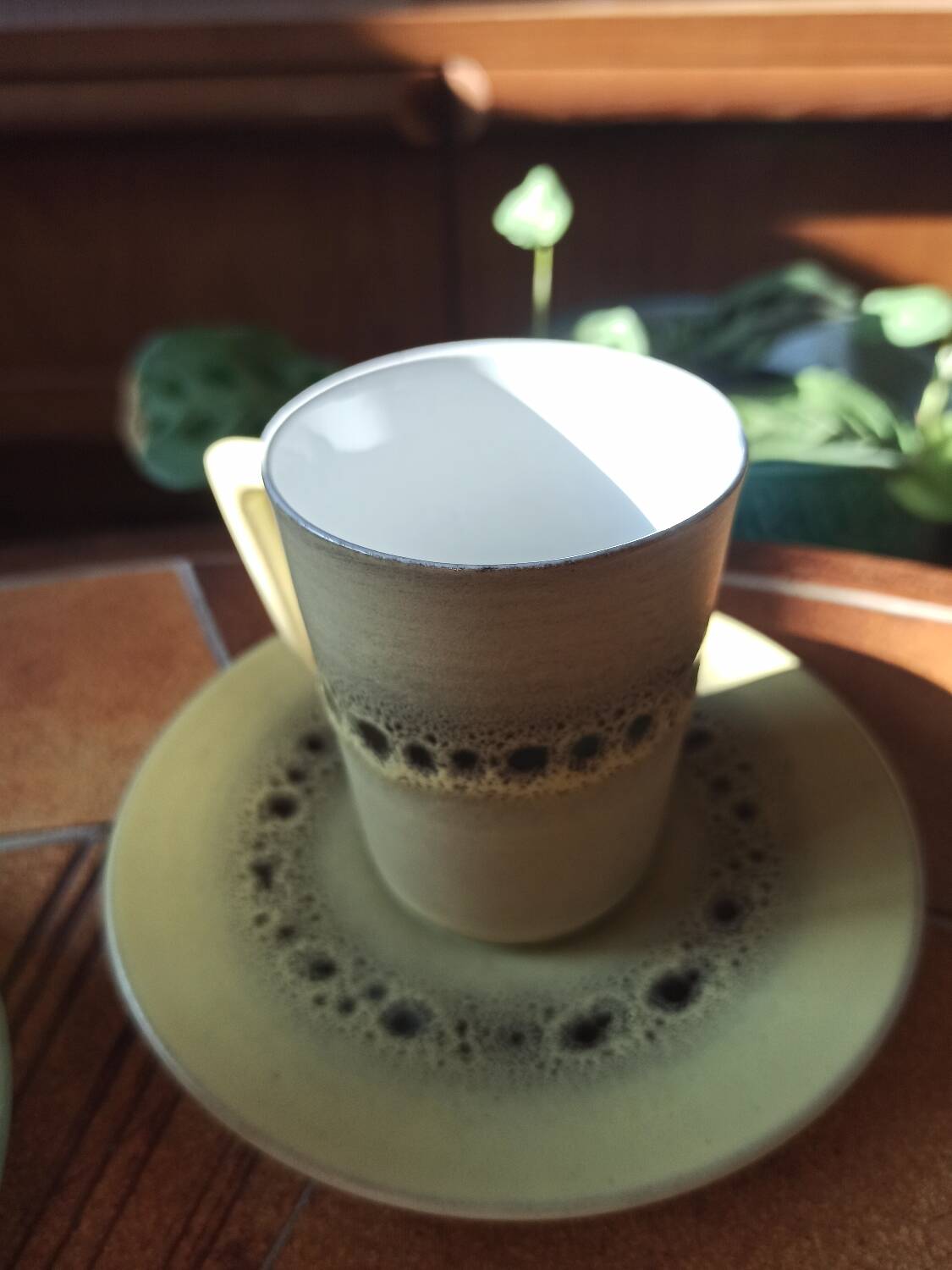 A pair of vintage glazed stoneware cups and saucers.