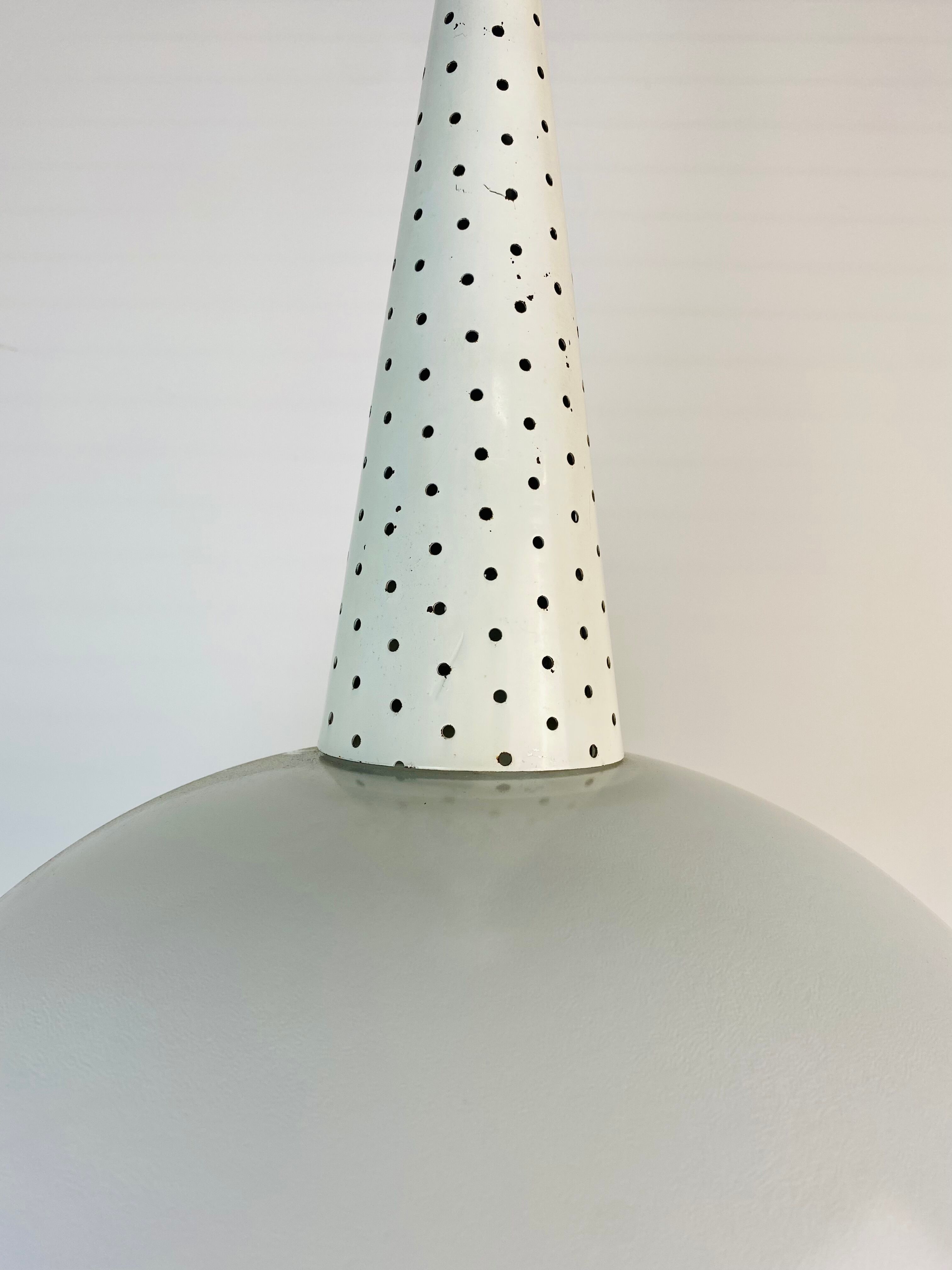 Perforated metal suspension holophanous glass