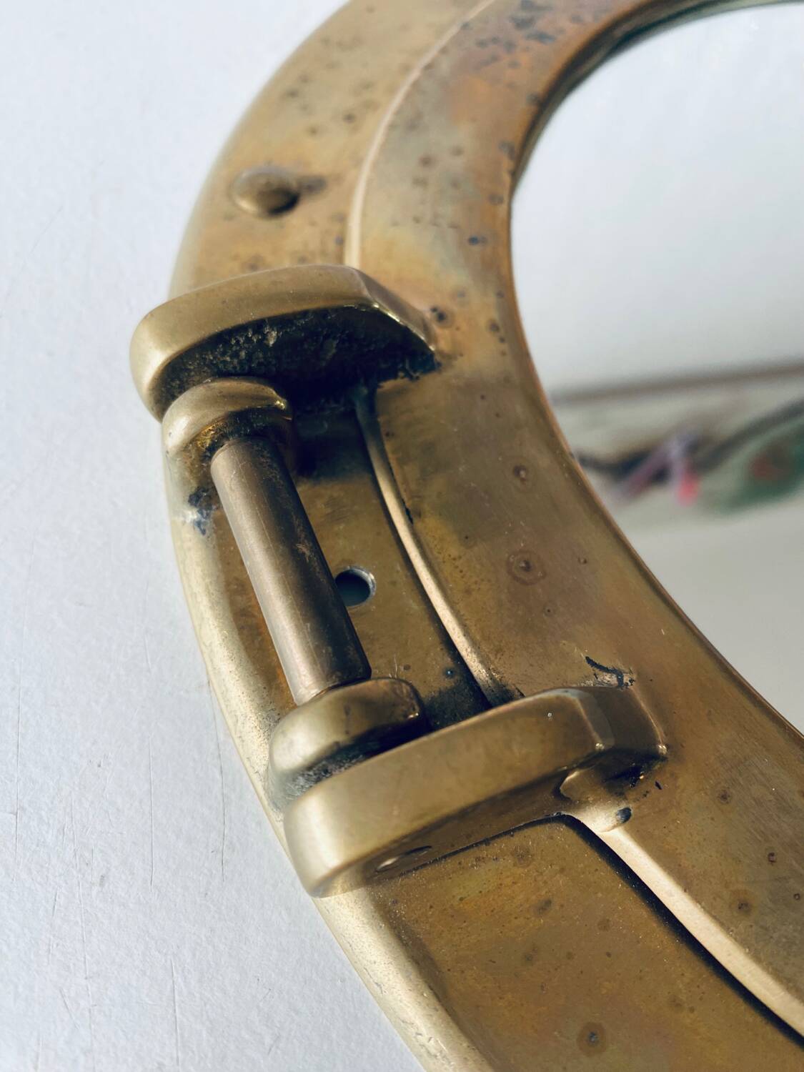 Porthole mirror in gilded brass