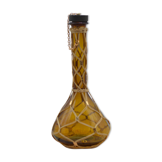 Amber decanter with wicker and golden chain