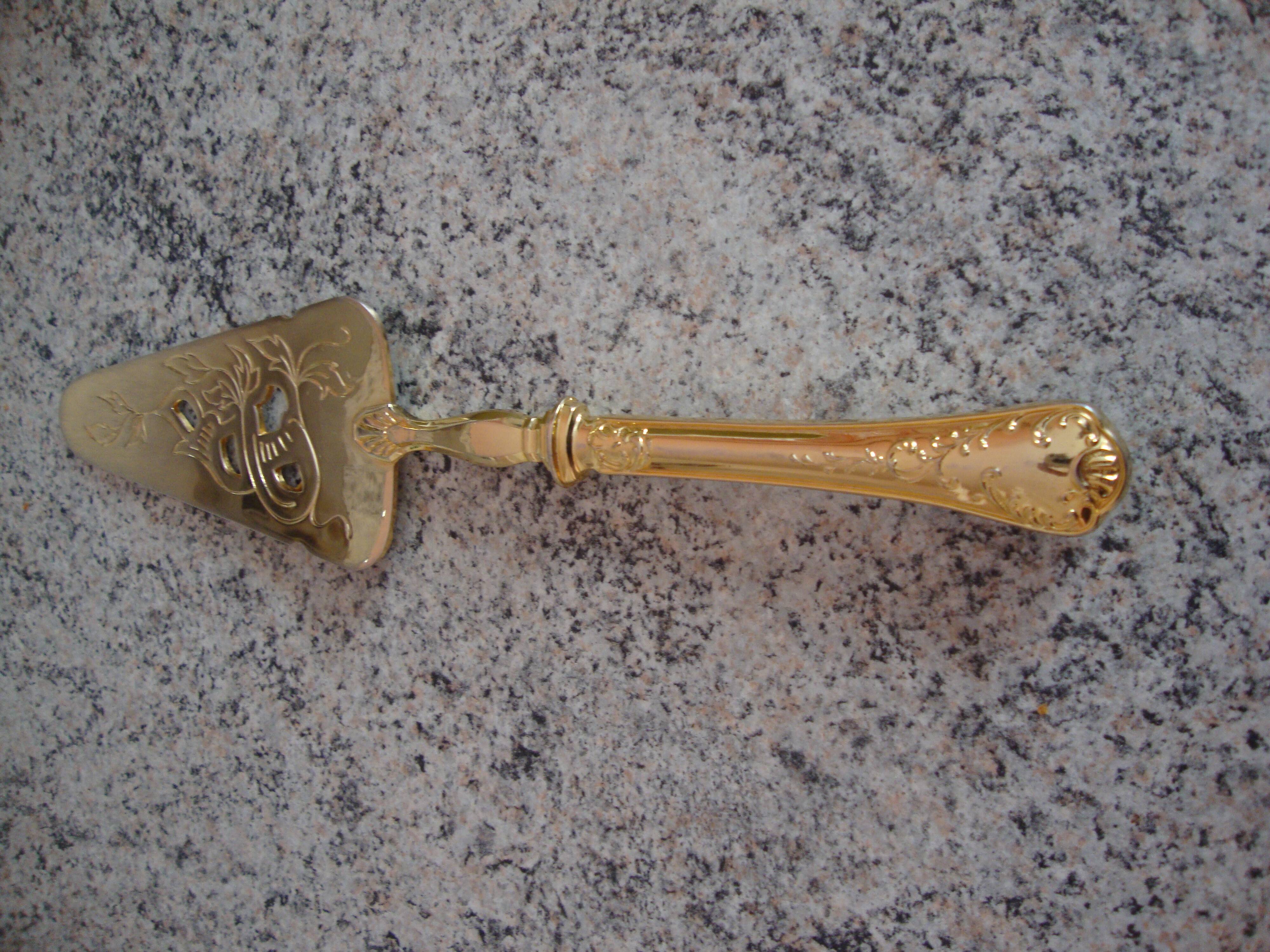Old gold metal pie shovel
