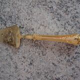 Old gold metal pie shovel