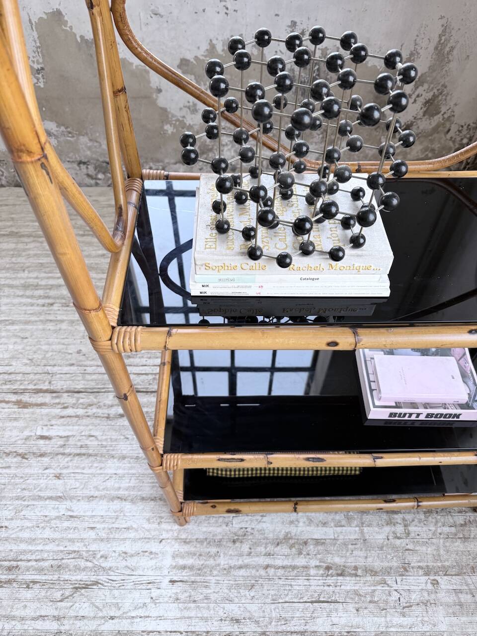 Rattan bookshelf and black glasses