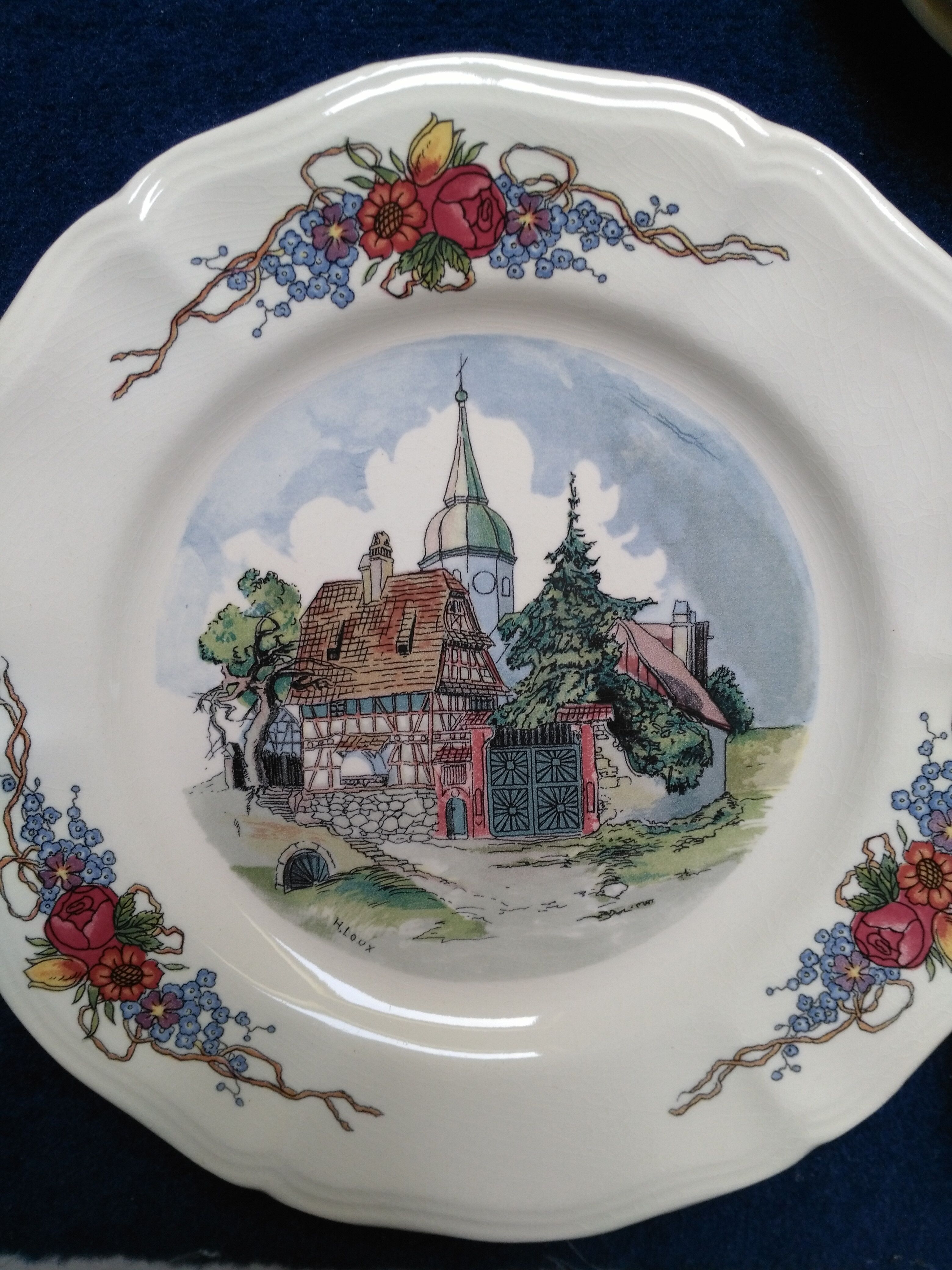 12 plates of the Obernai earthenware décor service signed Henri Loux