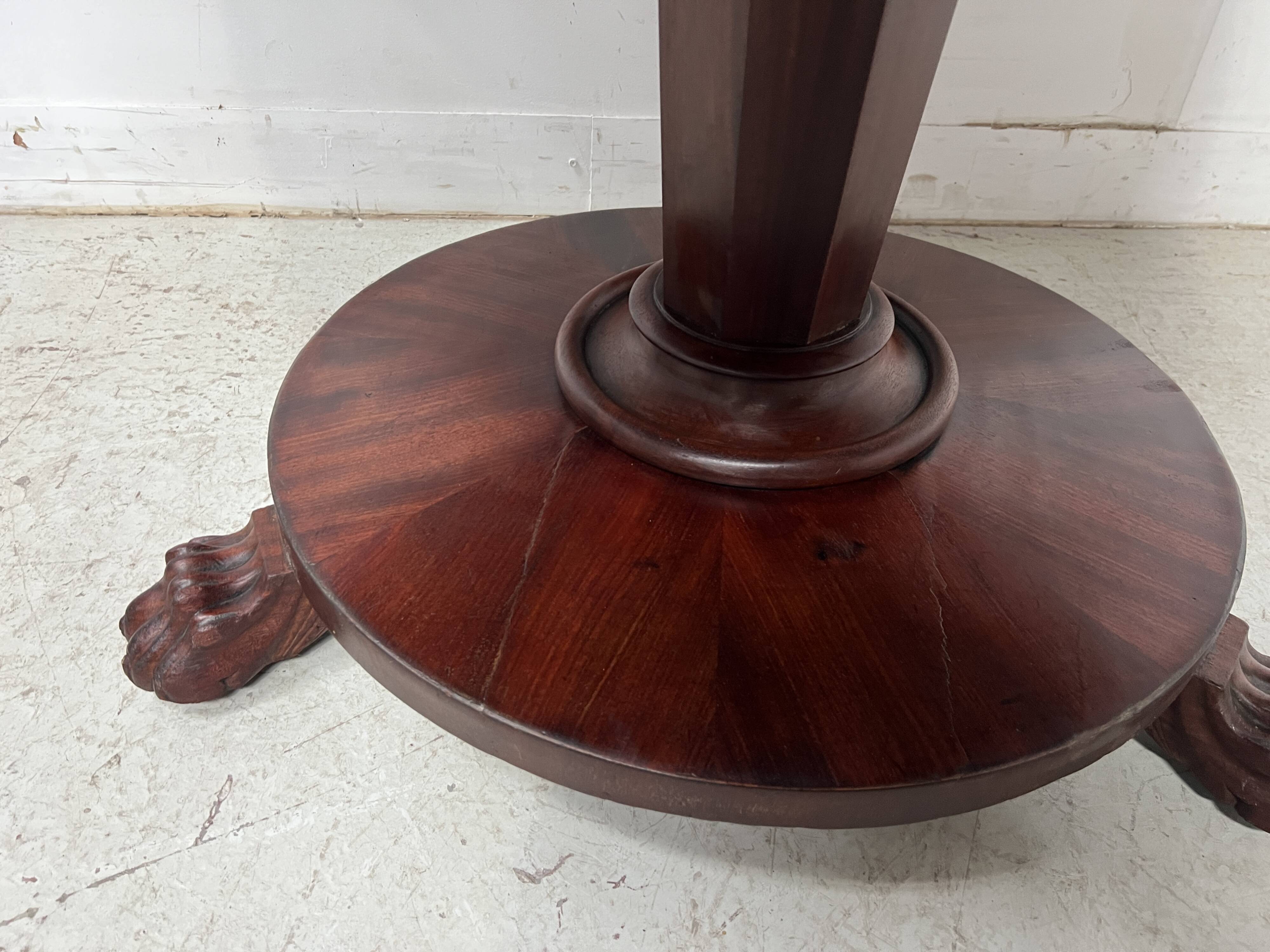 Empire style round table with claw feet, 19th century.