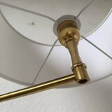 Floor lamp with articulated arm in brass-plated metal