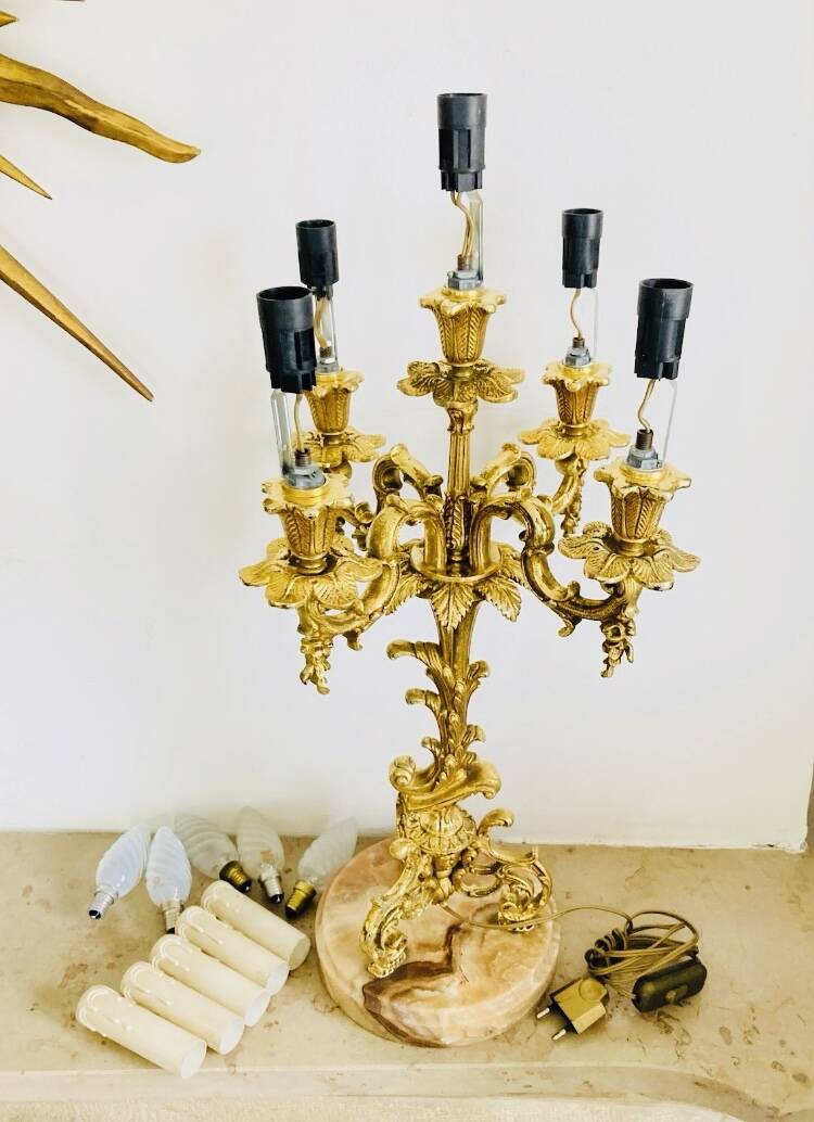 Massive gilded bronze chandeliers from the mid-20th century with marble bases.
