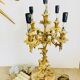Massive gilded bronze chandeliers from the mid-20th century with marble bases.