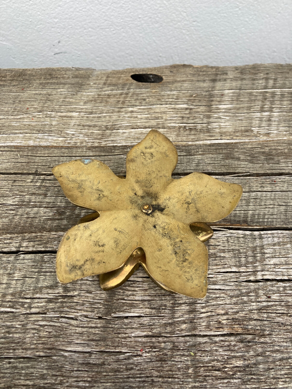 Old golden brass candle holder in the shape of a leaf or flower