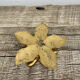 Old golden brass candle holder in the shape of a leaf or flower