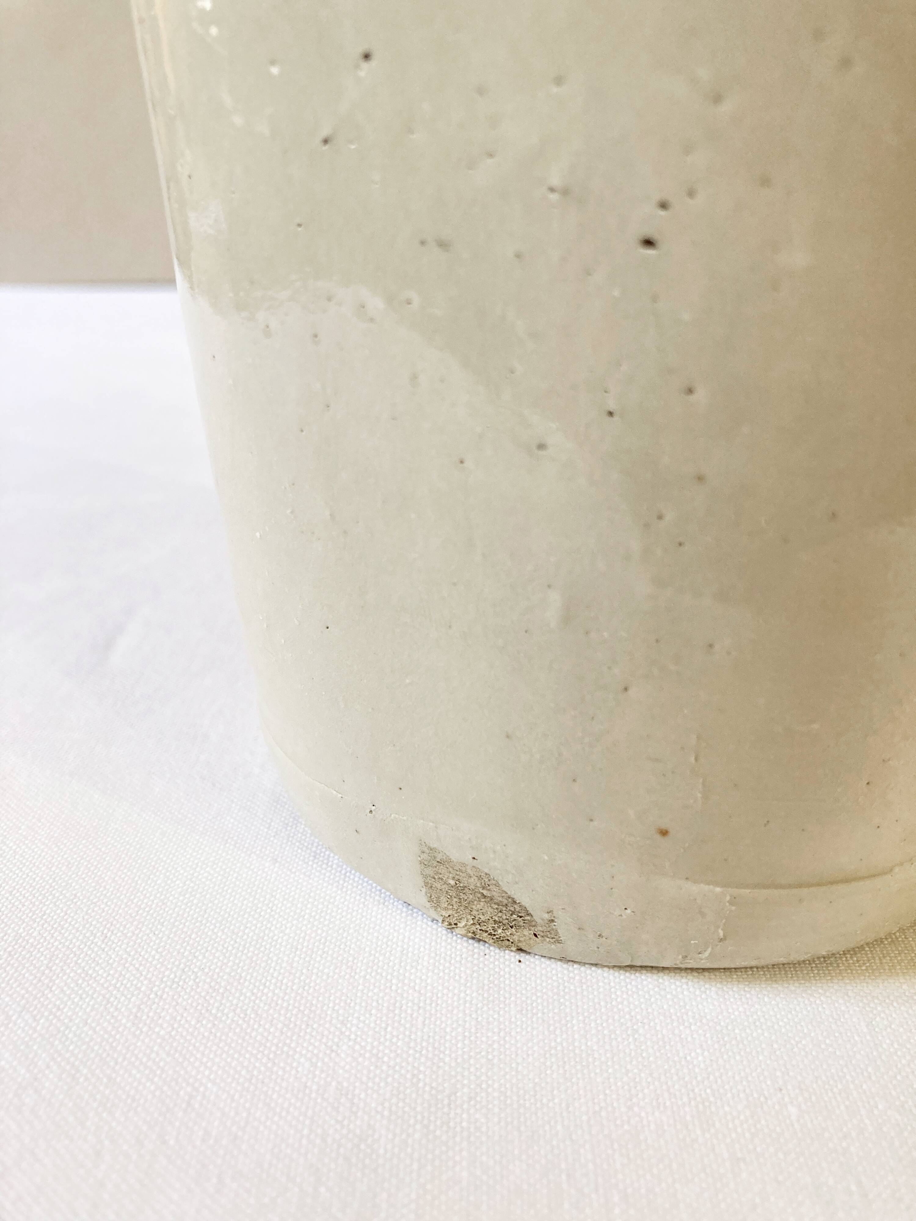 Old light gray enamelled stoneware hot water bottle