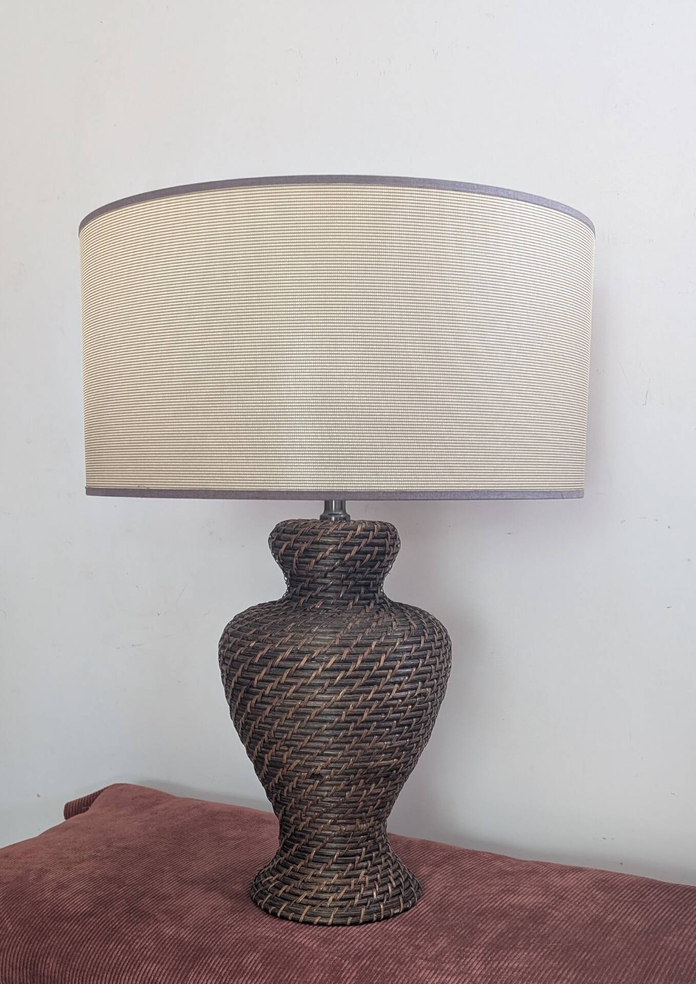 Vintage lamp in brown rattan with textured lampshade.