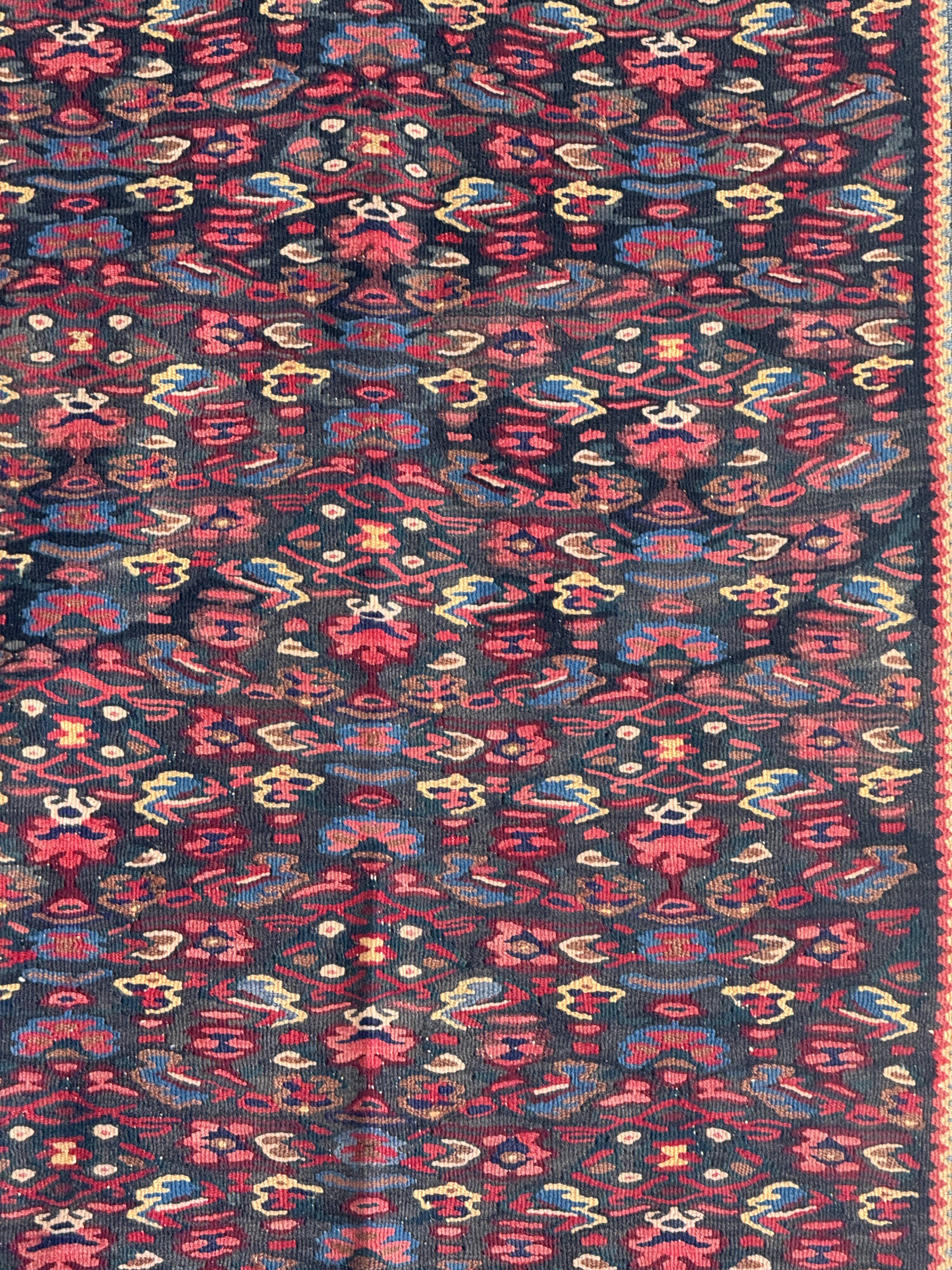 Iranian rug with stylised floral patterns in pink and blue, 155x105.