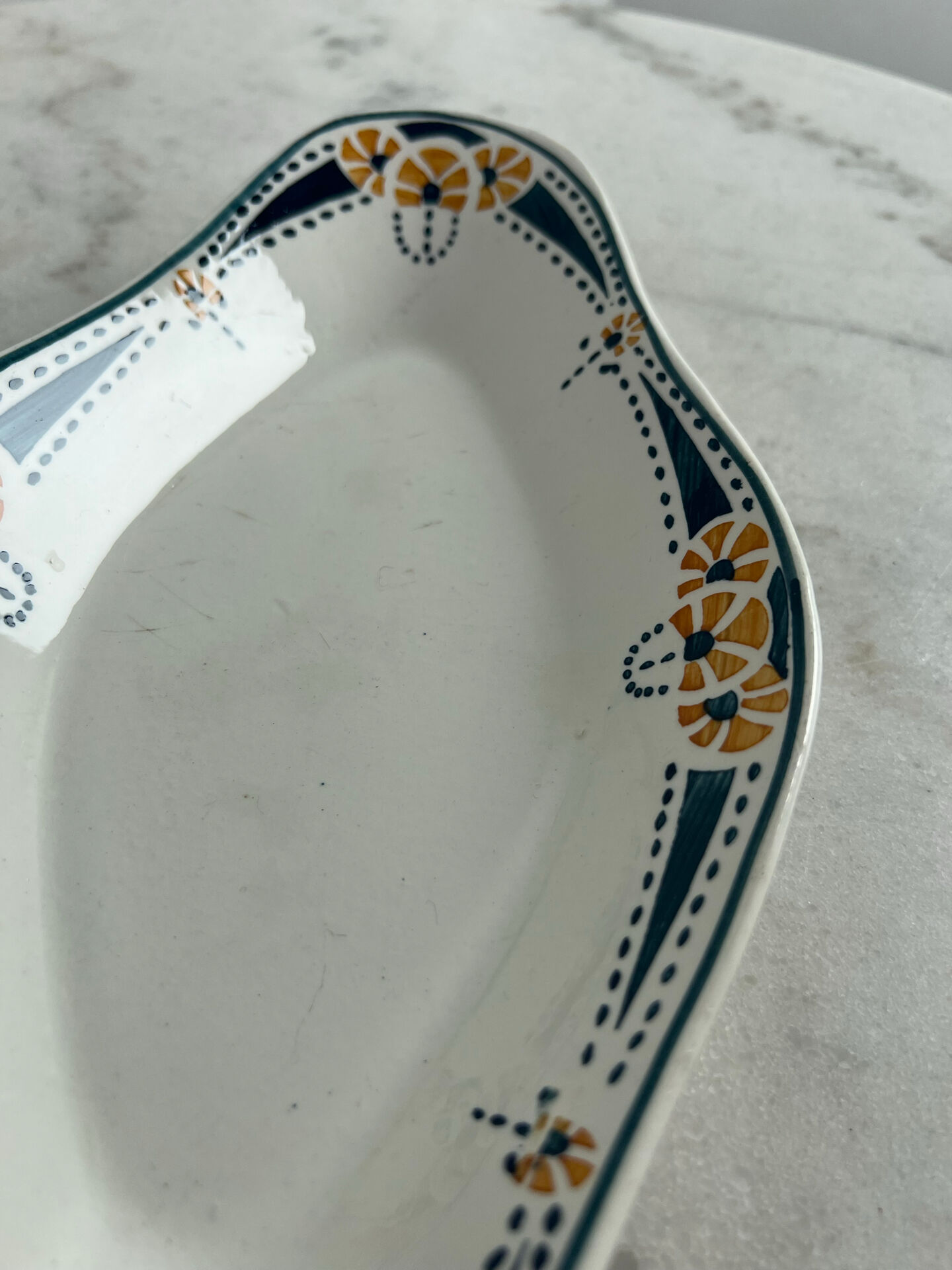 Longwy ramekin with blue and orange floral decoration.