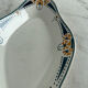 Longwy ramekin with blue and orange floral decoration.