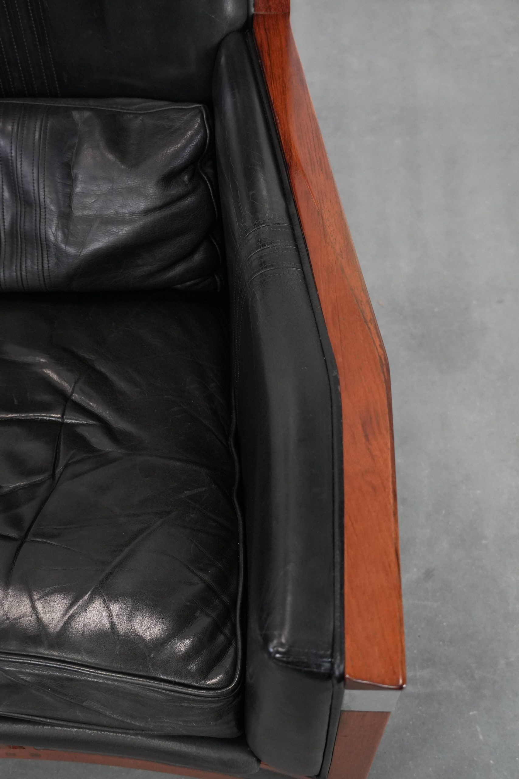 Black cowhide leather and wooden Art Deco design armchair