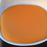 Vintage chair with tulip base in white lacquered metal pvc back and seat in orange Skaï.