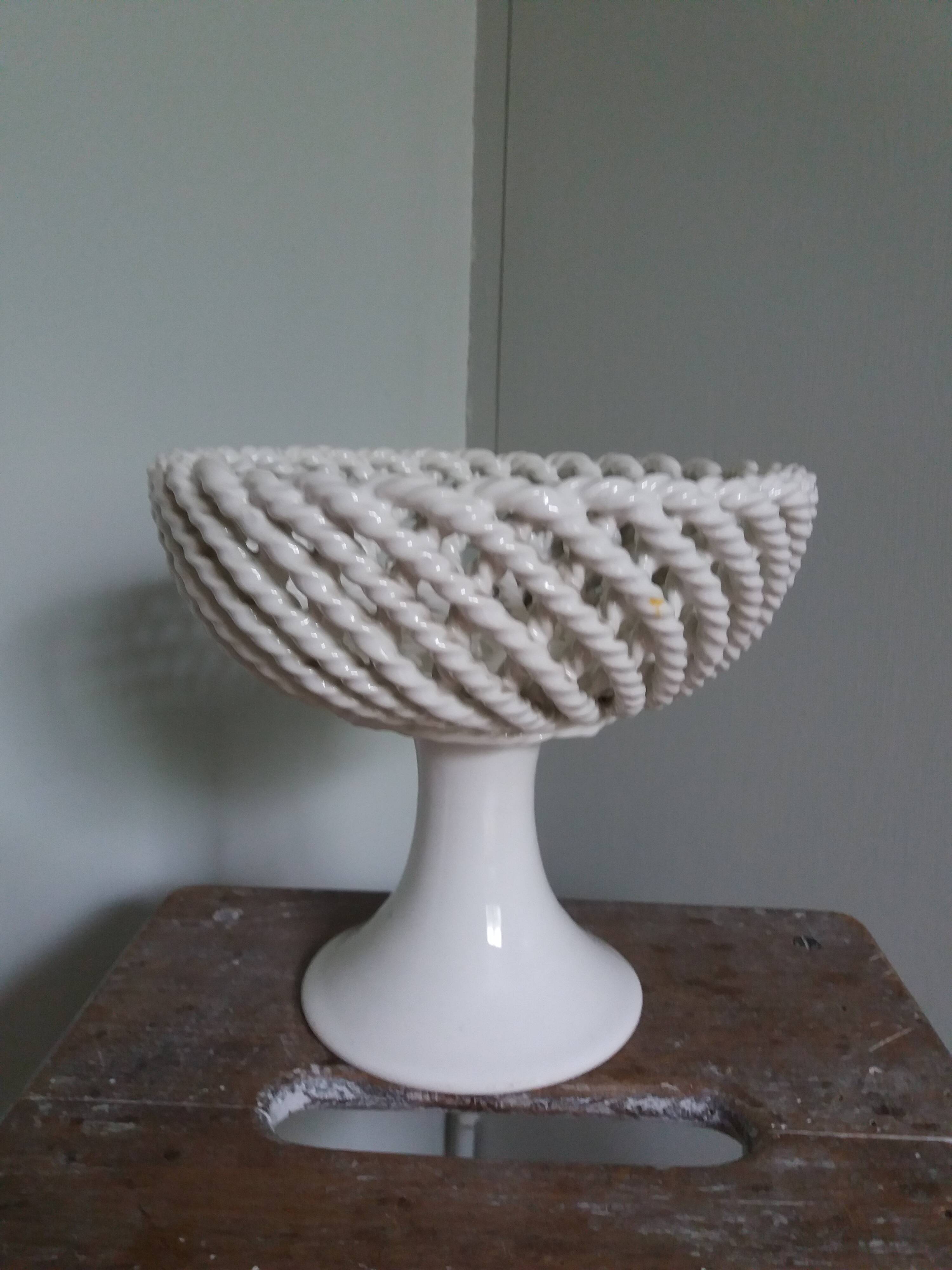 Cup on woven ceramic base with slip flowers