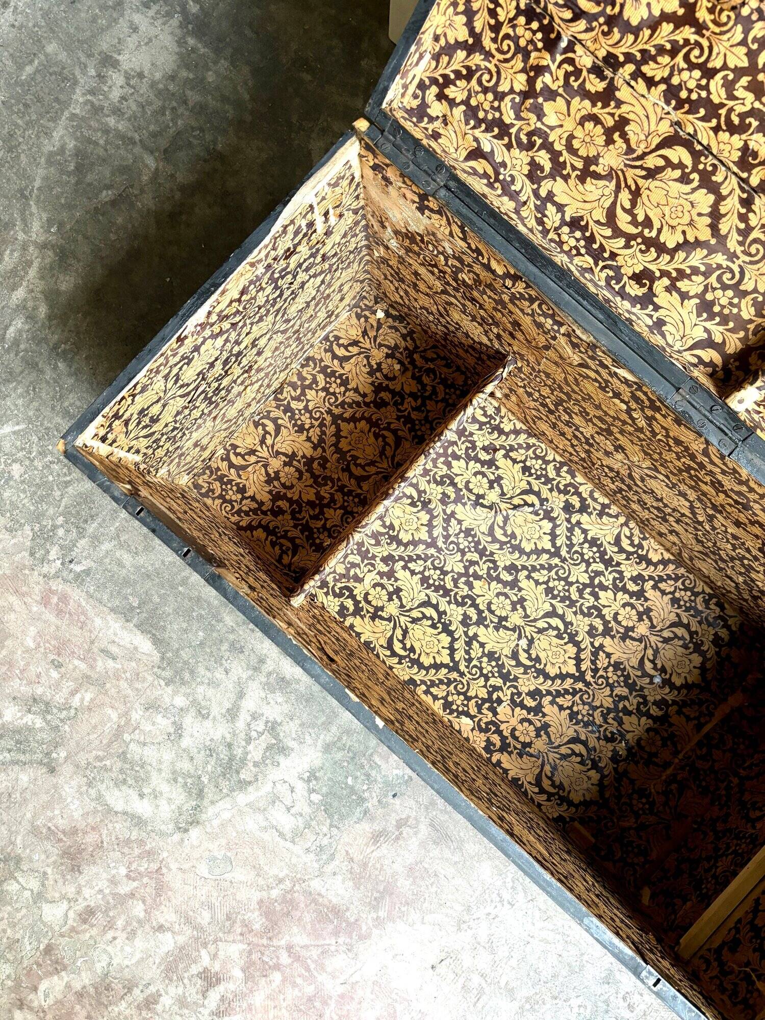 Trunk, black wooden chest and wallpaper