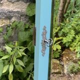 Beveled mirror on turquoise Parisian door