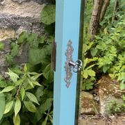Beveled mirror on turquoise Parisian door