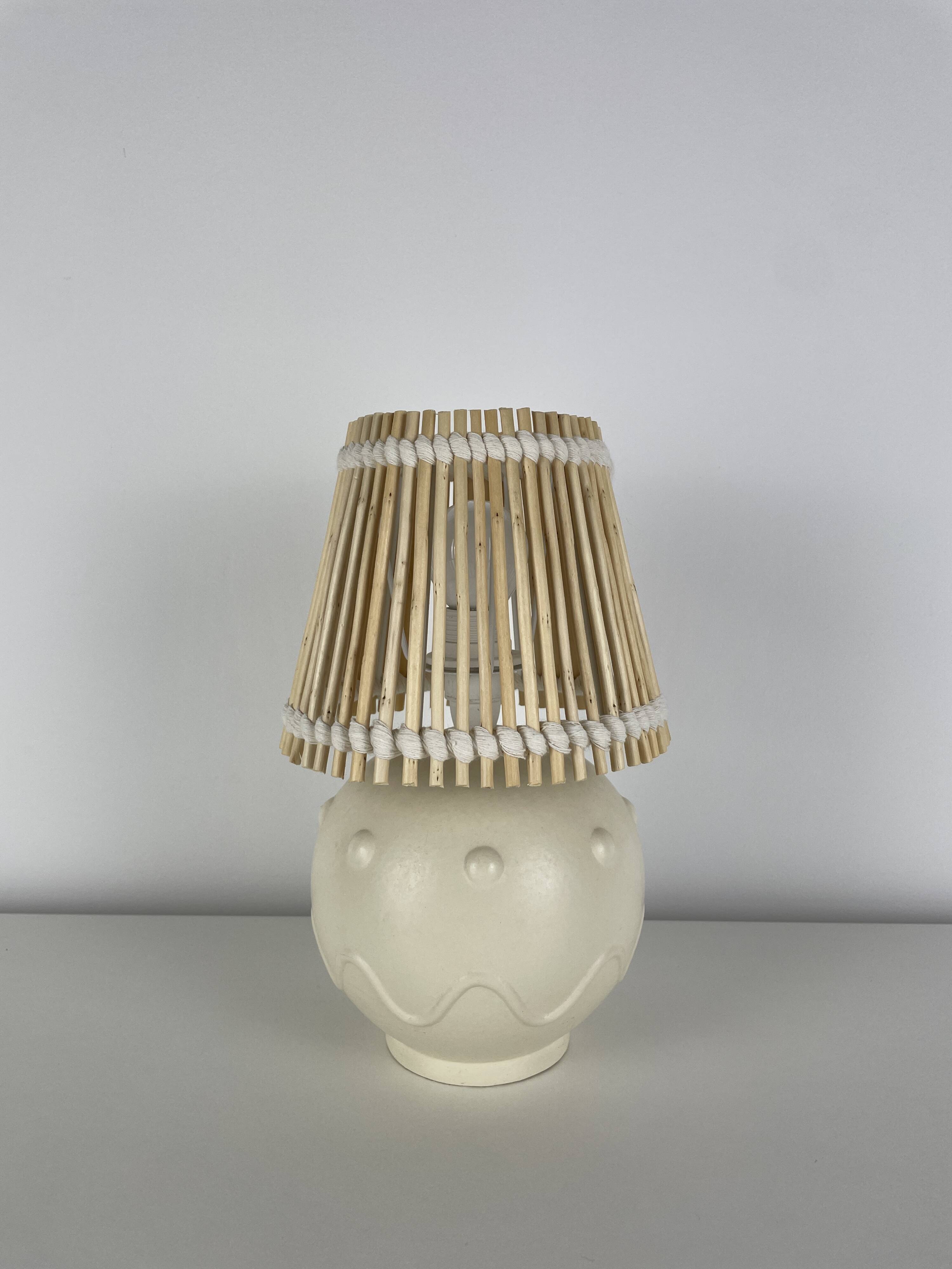 Vintage ceramic lamp with wicker and cotton shade.