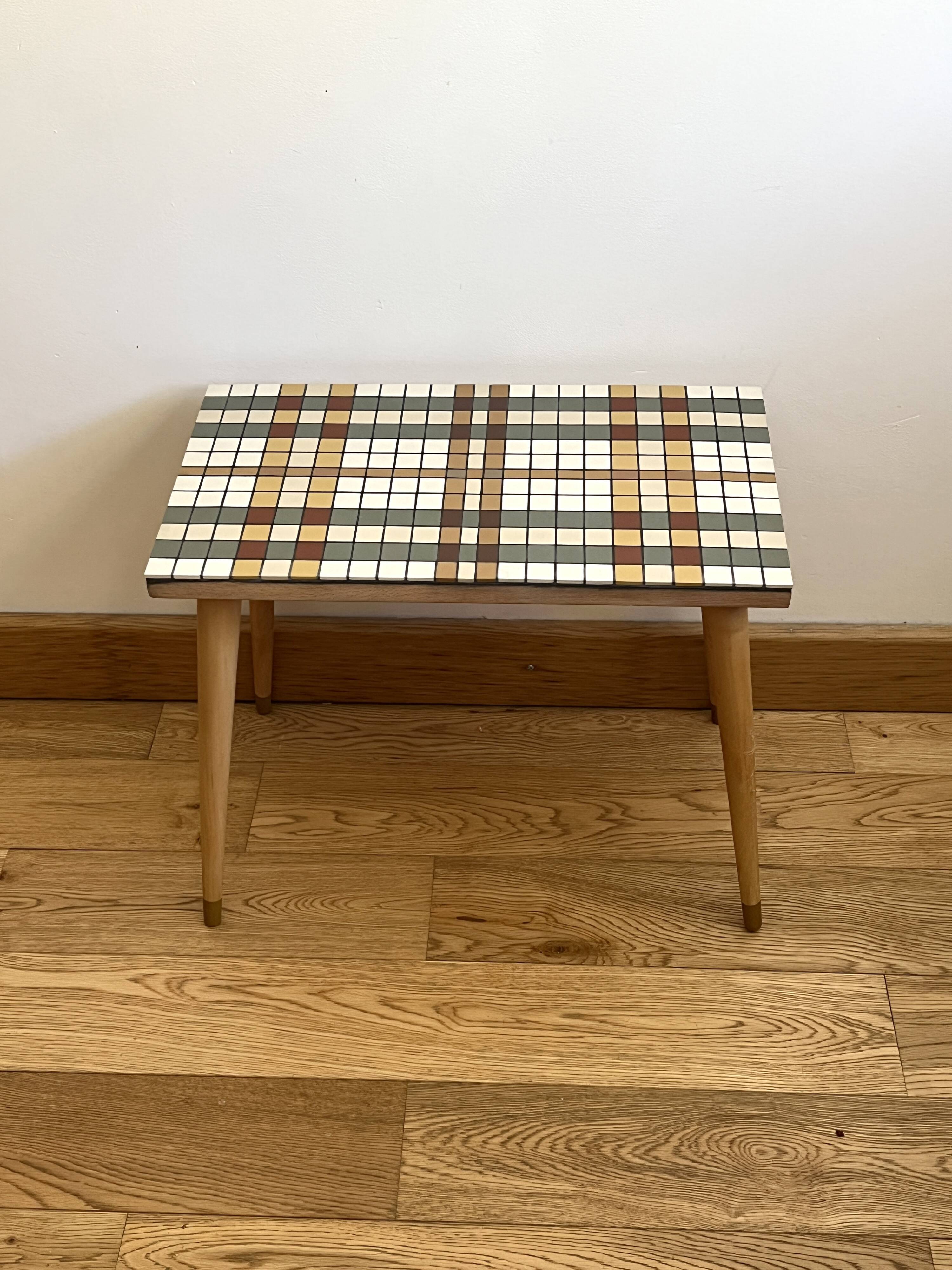 Small mosaic bedside table with tapered legs.