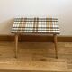 Small mosaic bedside table with tapered legs.