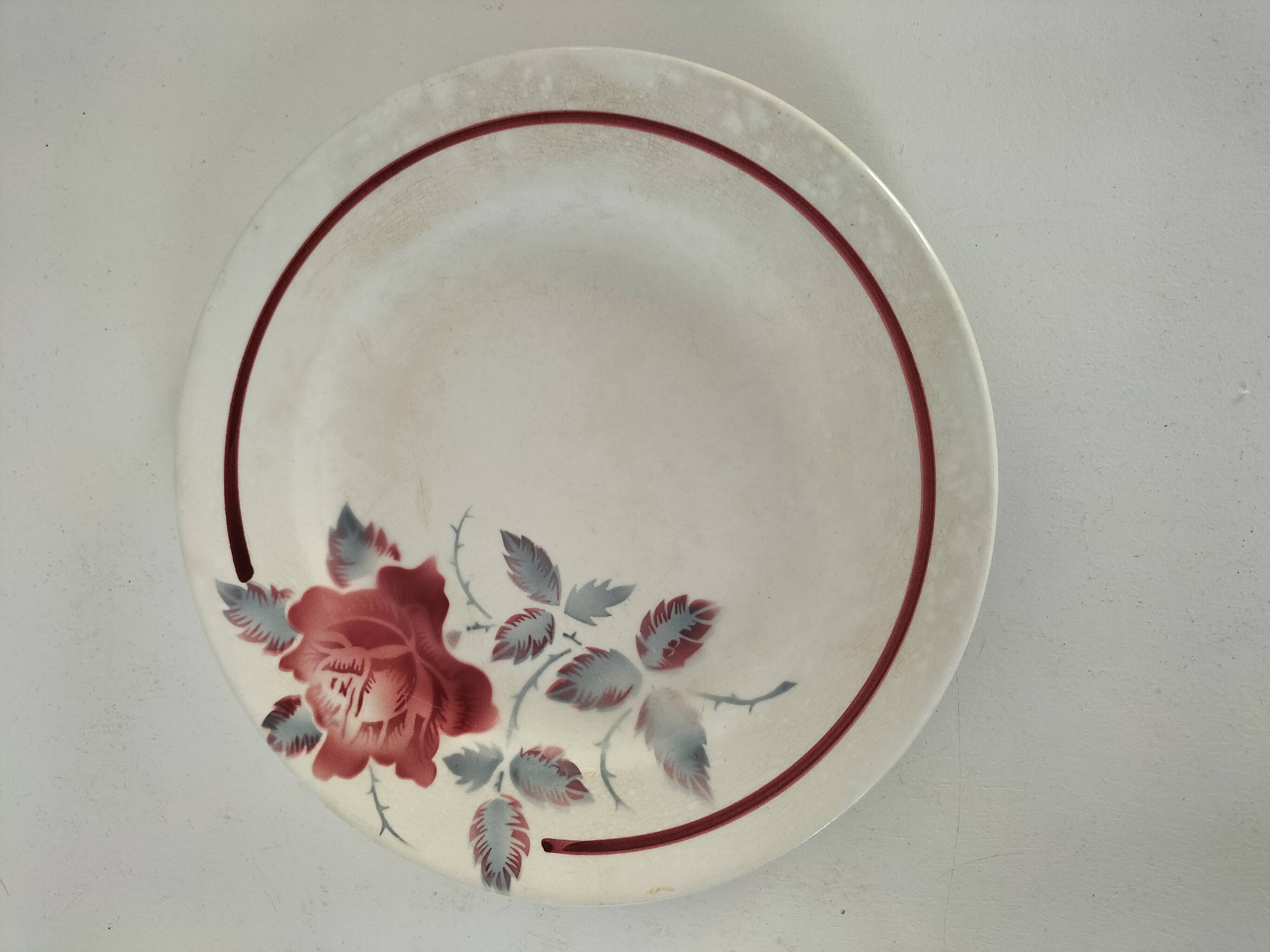 Set of 8 ironstone plates with coordinated designs.