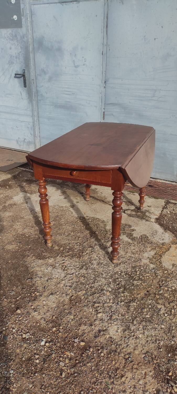 Old extendable round table in fruit wood with folding sides