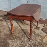 Old extendable round table in fruit wood with folding sides