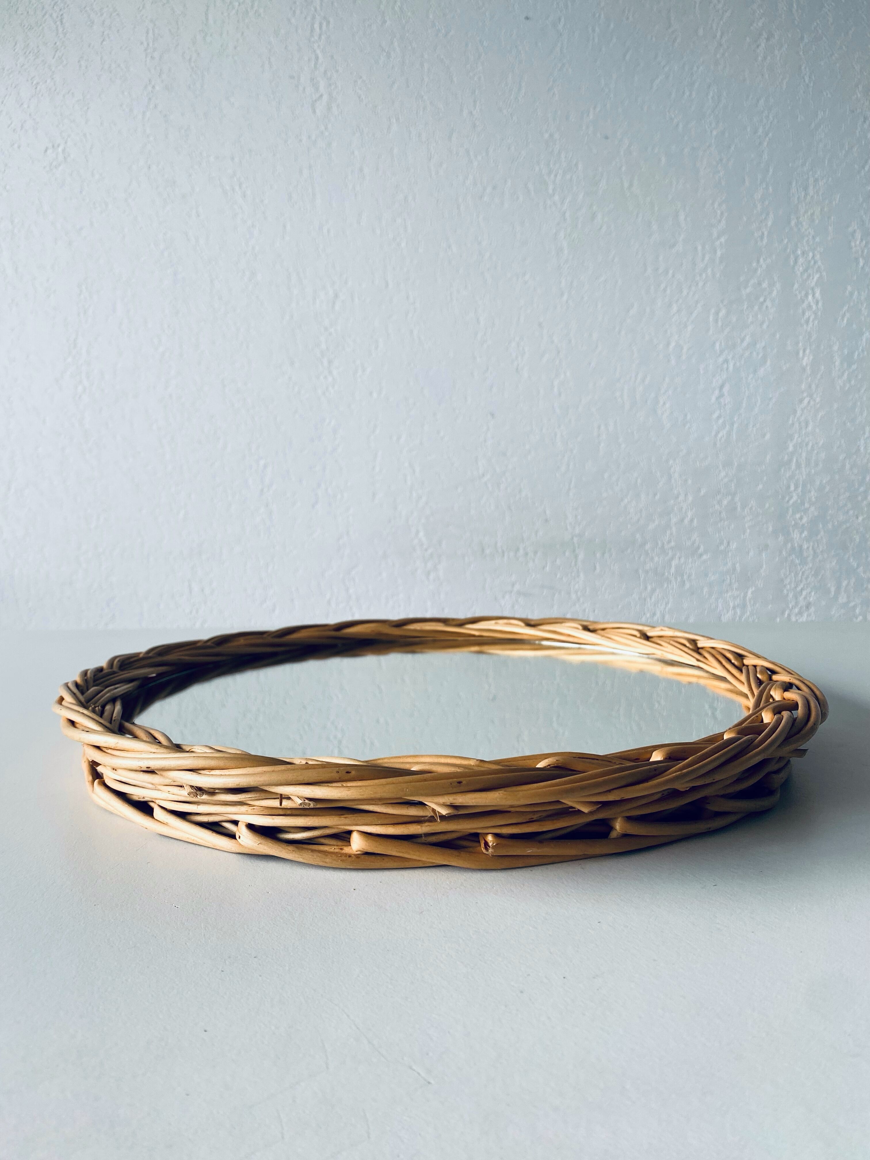 Round mirror in vintage wicker